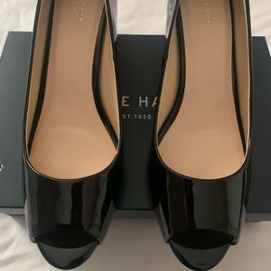 New never worn, black patent, peep toe wedge.